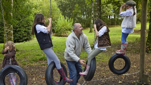 Family in the play area at Springhill, County Londonderry.